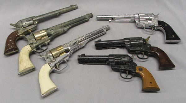 6 Vintage Toy Cowboy Pistols: 6 Vintage Toy Cowboy Pistols. The largest is 14'' long. various age and condition. SHI $20.