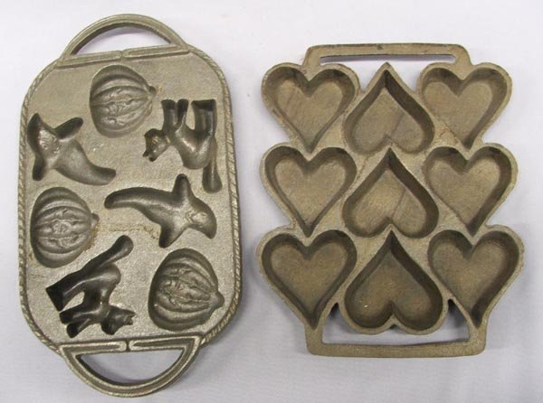 2 Cast Iron Holliday Molds: 2 Cast Iron Valentine Days Hearts and Halloween Molds. Measures approx. 11.5'' x 6.25''. SHI $20.