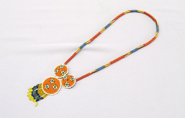 Chiricahua Apache Beaded Necklace With 3 Rosettes: Chiricahua Apache Beaded Necklace With 3 Rosettes. Measures 26'' end to end. Largest rosette is 1.75'' across. SHI $15.