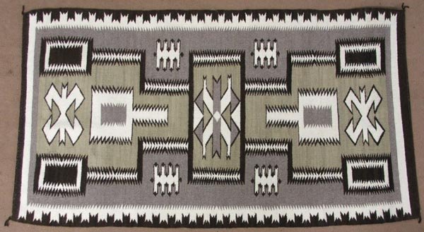 Vintage Navajo Storm Pattern Rug: Vintage Navajo Storm Pattern Rug, measures approx. 33'' x 58''. A backing has been tacked onto the rug, so as to hang on the wall or protect the rug if laid on the floor. Like new conditon. SHI $30.