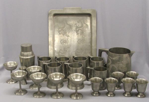 1940s Pewter Dragon Service For 6: 1940's Pewter Chinese Peking Dragon Service For 6. 6-Large Mugs, 6-Goblets, 6-Pedestal Cups, 1-Pitcher, 1-small Mug, 1-Measuring Cup, 1-Cocktail Shaker, 1-Tray. Tray measures approx. 16 1/2" x 11 3/4"