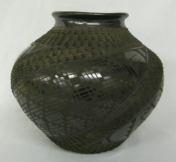 Mata Ortiz Black Textured Pottery by Mario Olivas: Mata Ortiz Black Textured Pottery by Mario Olivas. Measures 7''x8''. SHI $35.