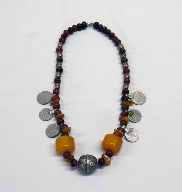African Beads Amber & Middle East Coins Necklace: African Beads, Amber, & Middle East Coins Necklace. Large antique silver African center bead measures 1''. End to end length is 20''. SHI $15.