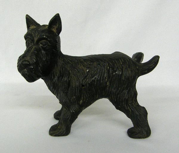 Cast Iron Scottie Dog Doorstop: Cast Iron Scottie Dog Doorstop. Measures 6''x7''. Figure is two-piece (two halves held together with a screw). SHI $20.