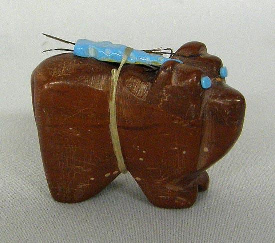 Zuni Pipestone Bear Fetish: Zuni Pipestone Bear Fetish, measures approx. 2''L x 1.5''H. Bear has turquoise eyes and turquoise arrowhead power pack. Signed on the bottom by artist. SHI $15.