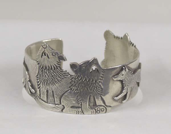 Navajo Sterling Wolf Design Bracelet By C Lee: Navajo Sterling Silver Wolf Design Bracelet By Clarence Lee. Measures approx. 6 1/2'' x 1 1/3''. SHI $15.