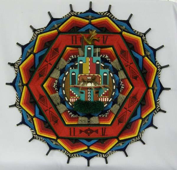 Hopi Wall Kachina: Hopi Wall Kachina, on back is written ''Home Katchina Hopi Tribe by Sandra Davis Old Oralilei Village Hopi Tribe 1978'', measures approx. 32'' in diameter. SHI $50.