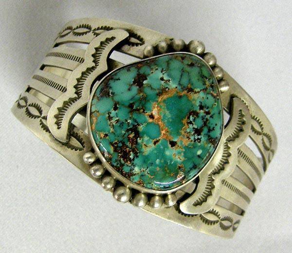 Navajo Silver Turquoise Bracelet by Edison Begay: Navajo Silver Turquoise Bracelet by Edison Begay. Pilot Mountain Turquoise with matrix that is rough to the touch. Measures 6.5'' inside including opening & 1.5'' wide. SHI $15.