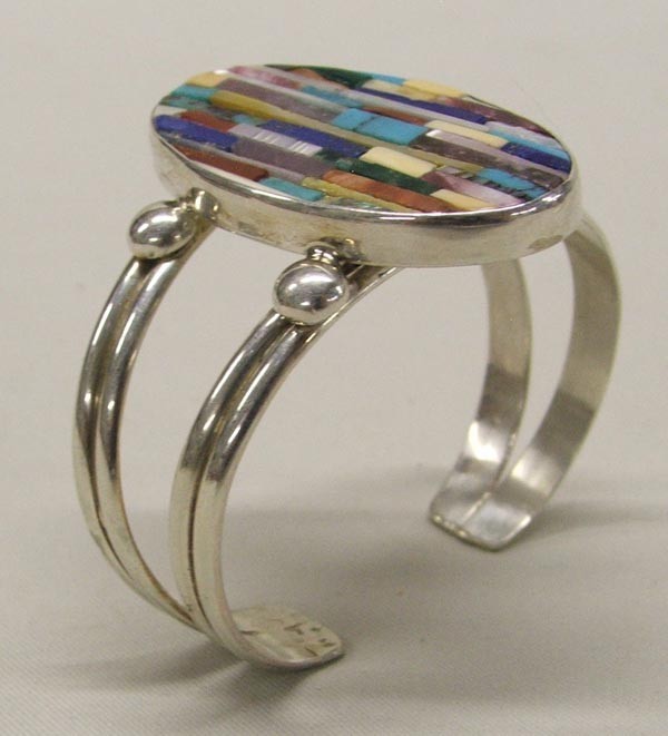 Santo Domingo Inlay Silver Bracelet by Rosetta: Santo Domingo Inlay Bracelet by Rosetta, hallmarked HR and stamped sterling, stones include turquoise, MOP, lapis, abalone, shell, malachite, inside measures approx. 6.75''. SHI $15.