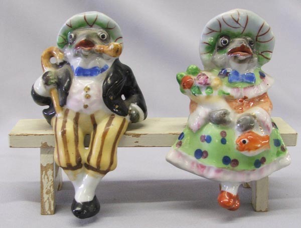 2 Occupied Japan Porcelain Frogs On A Bench: 2 Occupied Japan Porcelain Frogs On A Bench. Wood bench. Largest frog measures approx. 4'' x 2'', bench and frogs measures approx. 4.5'' x 6.5'' x 2.75''. SHI $20.