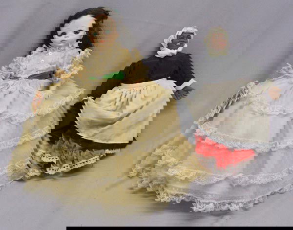 2 ''Gone With the Wind'' Dolls-Scarlet & Mammy: 2 ''Gone With the Wind'' Dolls-Scarlet & Mammy. Both dolls are in new condition. Scarlet measures 14'' tall. She has movable arms and legs, a crinoline and bloomers under her dress. Mammy has a soft,