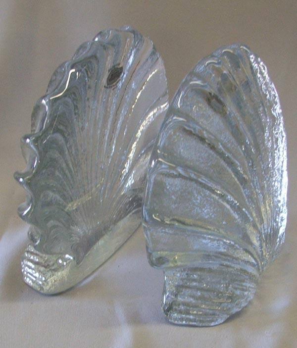 1 Pair Shell Shaped Blenko Glass Bookends: 1 Pair Shell Shaped ''Blenko'' Glass Bookends. Made in the USA. Measure approx. 6 1/2''H x 7''W. SHI $35.