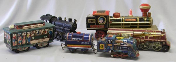 5 Tin And 1 Cast Metal Toy Trains: 5 Tin And 1 Cast Metal Toy Trains. Wind up does not work has been over wound. Largest measures approx. 10.5''. SHI $25.