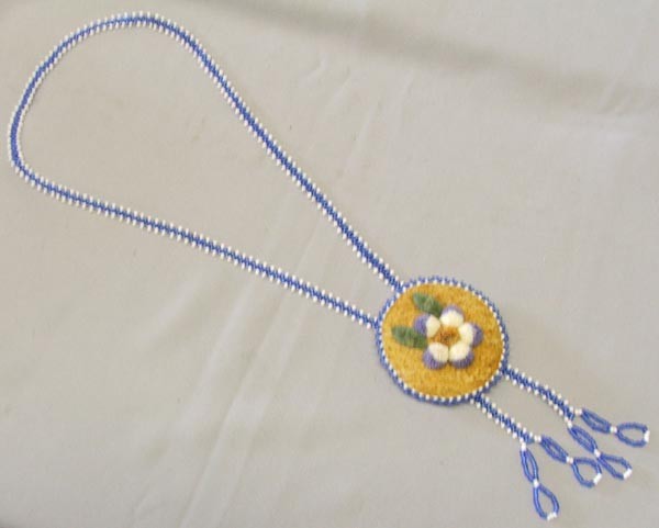 Ojibwa Beaded Necklace On Leather: Ojibwa Beaded Necklace On Leather. Moose Hair Embroidery. Measures approx. 3 3/4'' round. Beaded necklace measures approx. 34''. SHI $15.
