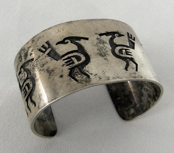 Hopi Silver Overlay Petroglyph Bracelet w/Hallmark: Hopi Silver Overlay Petroglyph Bracelet w/Hallmark. Measures 7'' inside including opening and 1.5'' wide. SHI $15.