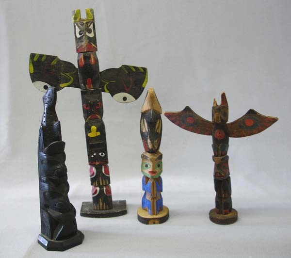 4 Totem Poles, 10'' and Smaller: 4 Totem Poles, 10'' and Smaller. The largest is 10''x6''. 3 are wood and the black one black composite. SHI $25.