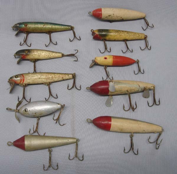 10 Antique Wood Fish Lures: 10 Antique Wood Fish Lures. 4 lures have glass eyes and 3 have painted eyes. The largest is the one with the silver fins and measures 5'' long. SHI $20.