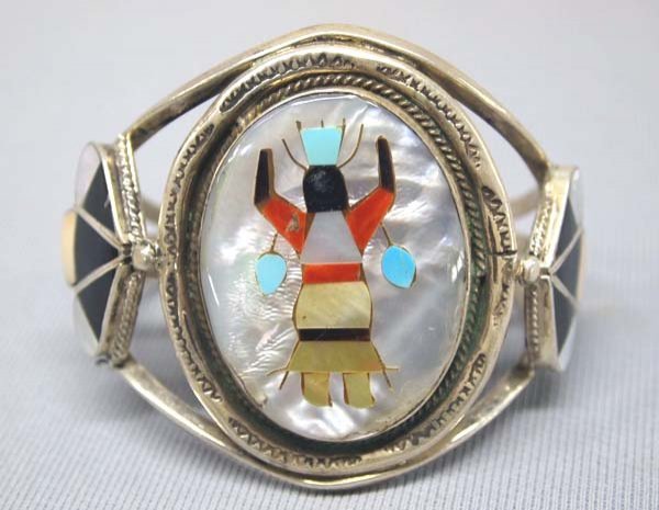 Zuni Silver MOP Turquoise Inlay Bracelet: Zuni Silver MOP Turquoise Inlay Bracelet. Apache Crown Dancer Turquoise, Coral, and Jet inlay on MOP. Measures 6''x2.25''. SHI $15