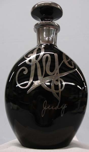 Vintage Silver on Glass Rye Decanter: Vintage Silver on Glass Rye Decanter. Says, ''Rye'' and ''Jane'' on decanter. Small chip on rim of decanter. Measures 9.25''x5''. SHI $25.