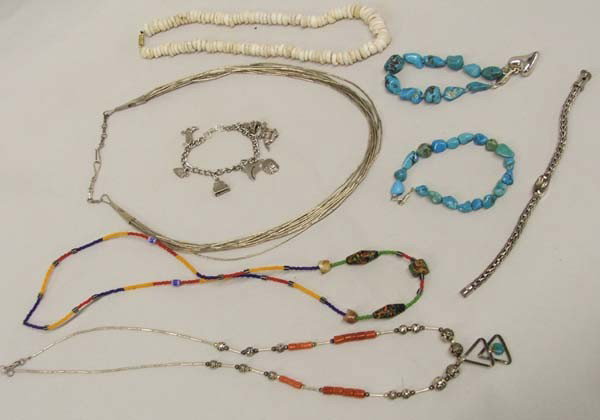 Collection of Native American Jewelry Plus: Collection of Native American Jewelry Plus. Charm Bracelet, 2 Turquoise Nugget Bracelets, Liquid Silver Necklace, 2 trade bead necklaces, choker of puka shells, and contemporary bracelet hallmarked Lo