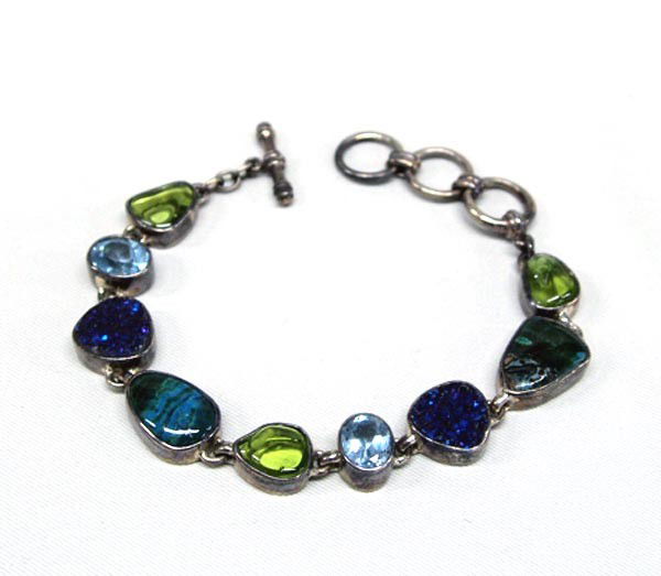 Sterling Silver & Semi Precious Stones Bracelet: Sterling Silver & Semi Precious Stones Bracelet. Peridot, Blue Topaz, Titanium Druzy, Chrysocalla. Hallmark on back of one setting, ''Starborn''. Length is adjustable 6.75''-8.25''. SHI $15.