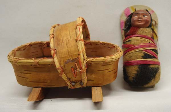 Native American Ojibwa Cradle & 1960 Skookum Doll: Native American Ojibwa Miniature birch bark Cradle & 1960 Skookum Doll on Cradle Board. Cradle measures approx. 2 3/4''H x 3 3/4''L x 2 3/4''W. Buyers Pay Actual Shipping and Handling Charges(see term