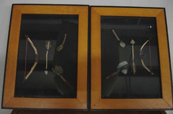 2 Framed Collections of Miniature Indian Weapons: 2 Framed Collections of Miniature Indian Weapons. The largest bow inside the frame is 4''. Frames measure 6-3/8''x8-3/8''. Buyers Pay Actual Shipping and Handling Charges(see terms and conditions for 