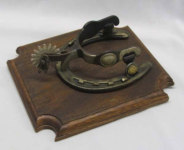 Spur Door Knocker On Wood Mounting: Spur Door Knocker On Wood Mounting, measures approx. 9''H x 7 3/4''W. Buyers Pay Actual Shipping and Handling Charges(see terms and conditions for more information).