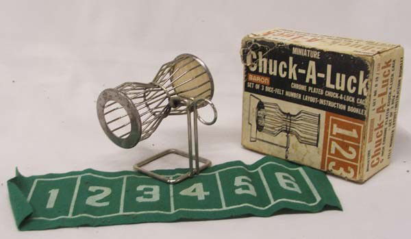 Vintage Baron Miniature Chuck-A-Luck Set: Vintage Baron Miniature Chuck-A-Luck Set. In original box. Box measures approx. 2 1/2''H x 5 1/2''L x 4 3/4''W. Some damage to top corner of box. Buyers Pay Actual Shipping and Handling Charges(see te