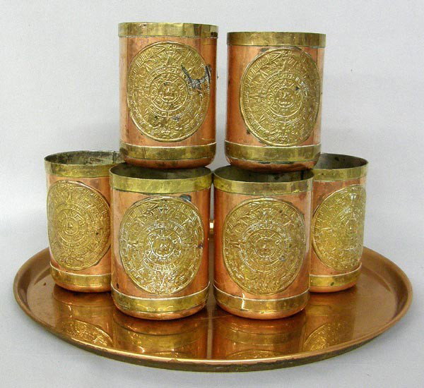 Aztec Style Brass & Copper Cups and Tray: 6 Brass & Copper Aztec Cups and Copper Tray. Cups measure approx. 4.25''Hx3.25''W, tray is approx. 13.75'' in diameter. Buyers Pay Actual Shipping and Handling Charges(see terms and conditions for mor
