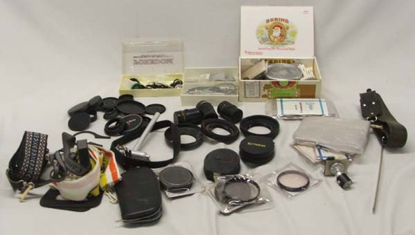 Miscellaneous Camera Items: Miscellaneous Camera Items: To include: 1 Box of Camera Caps and hoods and straps. Cleaning materials. Remote buttons and cables, etc. etc. Untested. Buyers Pay Actual Shipping and Handling Charges(se