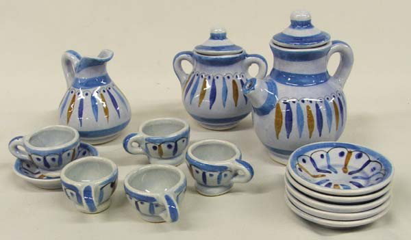 Child's Tea Set: Child's Tea Set. The tea pot measures approx. 4 3/4''H x 3 1/2''W. Tea pot, sugar, creamer, 6 saucers and 5 cups. One cup is broken. Buyers Pay Actual Shipping and Handling Charges(see terms and condi