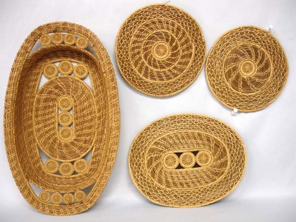 Matching Set of Four Pine Needle Baskets: Matching Set of Four Pine Needle Baskets. All have intricate woven designs. The oval basket measures 13.25''x7.75''x1.75''. The flat plates have felt backing. The round plates are 6.5'' diameter. The 