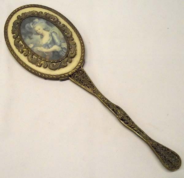 Antique Victorian Brass Filigree Hand Mirror: Victorian Brass Filigree Hand Mirror. 16.5''H x 5.5''W Picture of lady inserted on backside. Substantial weight. Beautiful work. Buyers Pay Actual Shipping and Handling Charges(see terms and condition