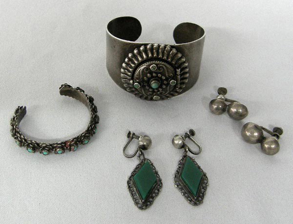 Mexican Silver Jewelry 2 Earring Pairs 2 Bracelets: Mexican Silver Jewelry 2 Earring Pairs 2 Bracelets. Lot includes 2 pair sterling earrings with screw backs. The diamond shaped earrings measure 1.12'' long. The larger bracelet has a locket and measur