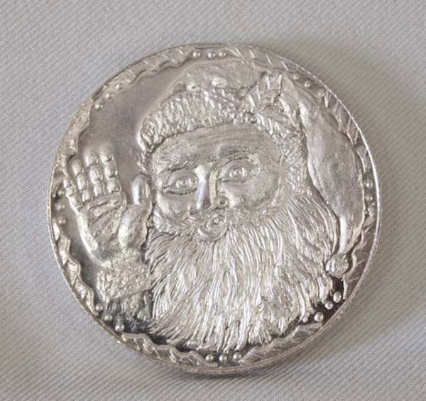 One Troy Ounce Pure Silver Santa Claus Round: One Troy Ounce Pure Silver Santa Claus Round, front of coin has waving Santa and marked on the back Happy New Year G.S.M. one oz .999 Silver. Buyers Pay Actual Shipping and Handling Charges(see terms