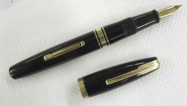 Waterman's Hundred Year Fountain Pen: Waterman's Hundred Year Fountain Pen. Waterman l4k 100 Year medium point nib. 5-1/4 inches long. Due to rough edge to the cap, top cap has been shaved down to the gold rim. See photograph. Buyers Pay