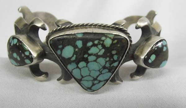 Native American Navajo Sandcast Bracelet by Perry: Native American Navajo SandCast Silver Turquoise Bracelet. Hallmarked ''Sterling, Perry. 6.75'' inside measurement and 1''W, triangular stone measures 1 1/8'' x 1'' at widest. Blue turquoise with blac