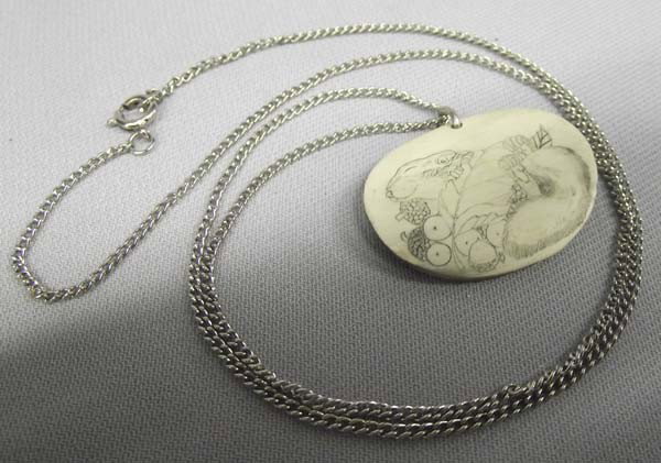 Scrimshaw Necklace: Scrimshaw Necklace, measures approx. 24'' end to end and pendant measures 1'' x 1 3/8'', has a squirrel on it. Buyers Pay Actual Shipping and Handling Charges(see terms and conditions for more informa