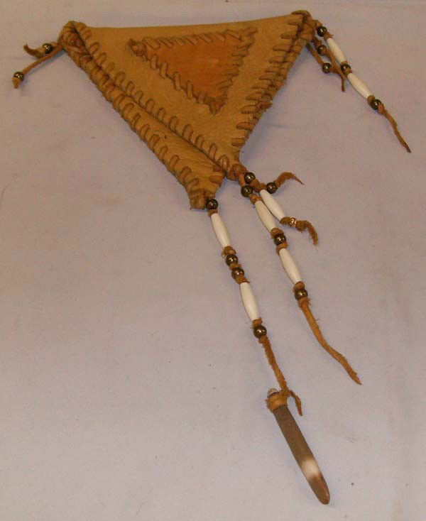 Elk Hide Pouch: Elk Hide Pouch. Double pocket inside flap. Stitched edges and brass bead and bone trim. Measures 14.5'' long including bead fringe. Pouch only is 7''x7''. Buyers Pay Actual Shipping and Handling Charg
