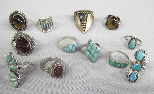 Collection Southwest Rings: Collection Southwest Rings. Some Zuni and some Navajo. Turquoise and Cats Eye/Petrified Wood. One ring sterling and turquoise hallmark ''ML''. Largest size 7.5. Buyers Pay Actual Shipping and Handling