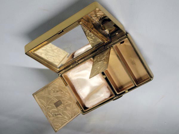 Antique Cosmetic Case and Black Faille Case: Antique Cosmetic Case and Black Faille Case. Made by ''Eligin American.'' The gold colored metal case appears unused and measures 4.75h''x3''w. Carrying bag made of black faille with strap that snaps