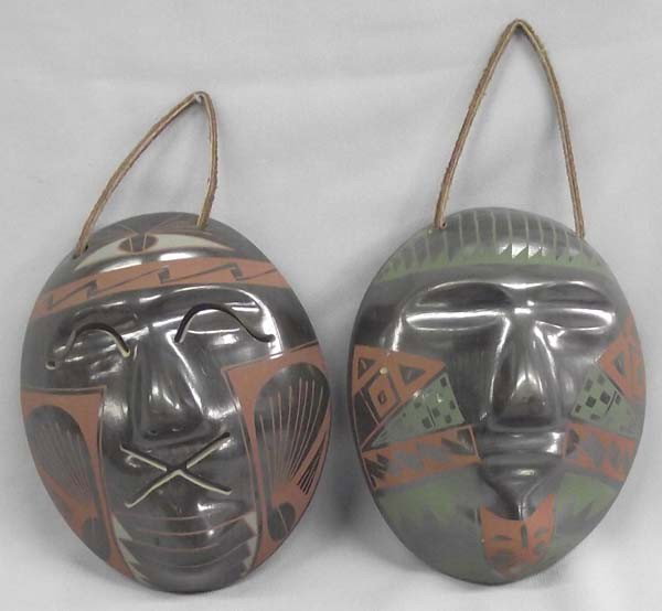 Mata Ortiz Polychrome Masks by Felipe Andrew: 2 Mata Ortiz Polychrome Masks by Felipe Andrew, they both are brown green and black however one has an X in place of the mouth, both have leather straps for hanging, measure approx. 5.75'' x 4.75''. B