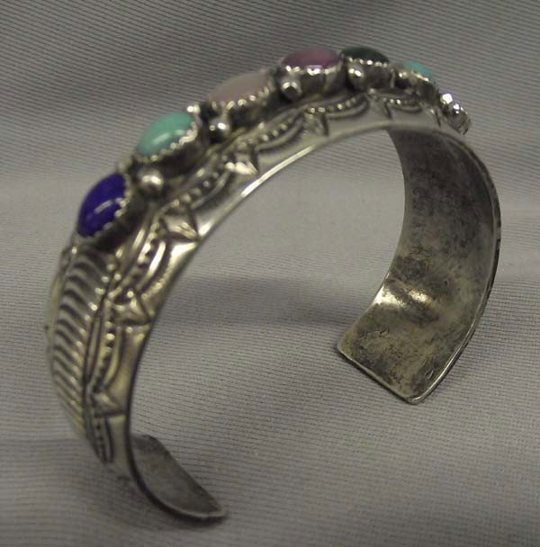 Navajo Sterling Silver Multi Stone Bracelet: Native American Navajo Sterling Silver Multi Stone Bracelet by William Begay. Hand stamped, Turquoise, Sugilite, Jet, Red Shell, MOP, Lapis, Ricolite. Measurement in Inches - Inside Length(Including O