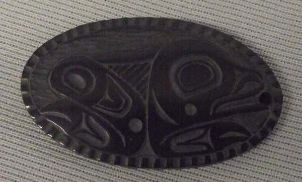 1997 Northwest Coast Carved Argillite Pendant: 1997 Native American Northwest Coast Carved Argillite Pendant by Denny Dwon. Small chip on one side. Measures approx. 1 3/4''L x 1''W. Buyers Pay Actual Shipping and Handling Charges(see terms and con