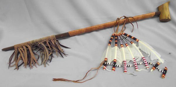 Plains Indian Wooden Pipe: Native American Plains Indian Wooden Pipe. Pipe is decorated with chicken feathers, ribbon wrapped handle, suede fringe. Measures approx. 30''L x 1 3/4''W. Buyers Pay Actual Shipping and Handling Char