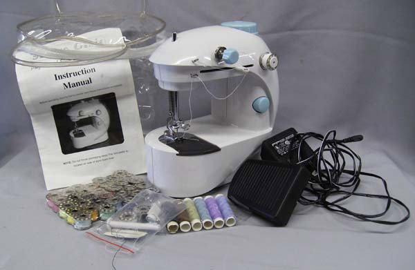 Miniature Sewing Machine ''Sewing Genie'': Sewing Machine ''Sewing Genie'', professional style. Can be battery or AC/DC operated. With bobbin winder, 32 full bobbins plus extra thread cones. Machine has a tension control, foot pedal operation.
