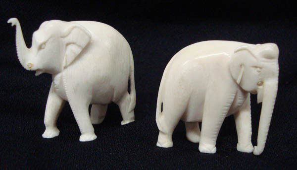 Two Ivory Carved Elephants: Two Ivory Carved Elephants, each with a missing tusk. 1.75'' H x 1.5'' W. Buyers Pay Actual Shipping and Handling Charges(see terms and conditions for more information)