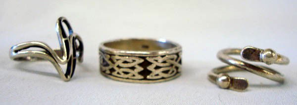 Three Sterling Rings: Three sterling rings. Largest band is stamped 925 and is size 12; The double front designed ring is size 7.5; the wrap around sterling ring band is size 5.5 and is adjustable. Buyers Pay Actual Shippi