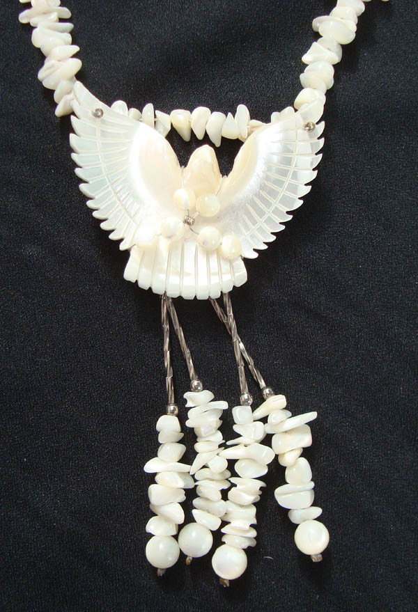 Yaqui Mother of Pearl Eagle Pendant Necklace: Native American, Mother of Pearl chips & carved eagle necklace with liquid silver twist beads, sterling silver long oval beads. Made by Yaqui Indians from San Xavier del Bak Mission, 1968. 26'' length